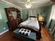 Bedroom featuring a four-poster bed, dresser, hardwood floors, and floral wallpaper border at 111 Newington Rd, Summerville, SC 29485