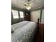 Bedroom featuring a bed with patterned quilt, wood floors, and two windows at 111 Newington Rd, Summerville, SC 29485