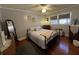 Comfortable bedroom featuring neutral walls, wood floors, dresser, mirror and a large window at 111 Newington Rd, Summerville, SC 29485