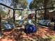Backyard fire pit area featuring swing seats, perfect for social gatherings and outdoor enjoyment at 111 Newington Rd, Summerville, SC 29485