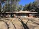 Charming brick ranch-style home with mature trees and covered front porch at 111 Newington Rd, Summerville, SC 29485