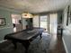 Relaxing game room with covered pool table, rug, and access to the backyard at 111 Newington Rd, Summerville, SC 29485