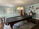 Inviting game room featuring a covered pool table and a decorative, stained-glass chandelier at 111 Newington Rd, Summerville, SC 29485