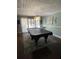 Game room showcasing a pool table with a stained-glass chandelier and herringbone wood flooring at 111 Newington Rd, Summerville, SC 29485