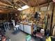 Interior view of the garage with multiple tools hanging from walls, work bench and ceiling fan at 111 Newington Rd, Summerville, SC 29485