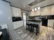 A cozy kitchen offers white cabinets, black countertops, and a unique ceiling accent at 111 Newington Rd, Summerville, SC 29485