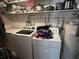 Laundry room features modern appliances, white cabinets, and ample storage, designed for convenience at 111 Newington Rd, Summerville, SC 29485