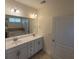 Bright bathroom with double sink vanity, large mirror, and bath at 113 Doral Blue Dr, Summerville, SC 29483