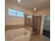 Well-lit bathroom with soaking tub and glass enclosed walk-in shower at 113 Doral Blue Dr, Summerville, SC 29483