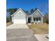 Charming gray home with a two-car garage and well-manicured lawn at 113 Doral Blue Dr, Summerville, SC 29483