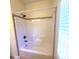 Modern bathtub with shower, light-colored walls, and tiled shower trim at 113 Doral Blue Dr, Summerville, SC 29483