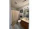 Well-lit bathroom featuring a shower with a neutral curtain and a wood vanity at 120 Hornby Cir, Goose Creek, SC 29445