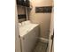 Compact laundry room featuring a washer, dryer, and shelving for storage at 120 Hornby Cir, Goose Creek, SC 29445