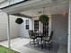 Covered patio area with a table and chairs set, decorative string lights, and hanging planters at 120 Hornby Cir, Goose Creek, SC 29445