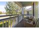 Relaxing balcony with wicker seating and a view of trees and other buildings at 1225 Blakeway St # 403, Charleston, SC 29492