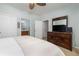 A well-lit bedroom with a TV on a dresser, plush bed, and view into the attached bathroom at 1225 Blakeway St # 403, Charleston, SC 29492