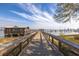 Scenic boardwalk with views of the pier, waterfront buildings, and marina at 1225 Blakeway St # 403, Charleston, SC 29492