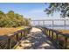 Scenic boardwalk with views of boats sailing on the water under a long bridge at 1225 Blakeway St # 403, Charleston, SC 29492