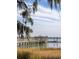 Exterior view of a wood dock with boat parking on the water, clear sky, and trees at 1225 Blakeway St # 403, Charleston, SC 29492