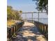 Exterior view of a wooden boardwalk leading up to bridge with boats sailing on the water at 1225 Blakeway St # 403, Charleston, SC 29492