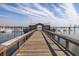 Exterior view of a wood dock and gazebo with boat parking and blue skies on the water at 1225 Blakeway St # 403, Charleston, SC 29492