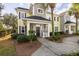 Charming two-story townhouse with a welcoming front porch, landscaped garden, and a well-lit entryway at 1225 Blakeway St # 403, Charleston, SC 29492
