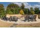 Inviting outdoor fire pit with Adirondack chairs and a stone surround perfect for gathering and relaxation at 1225 Blakeway St # 403, Charleston, SC 29492