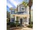 Charming exterior view of a two-story townhome with a covered porch and lush landscaping at 1225 Blakeway St # 403, Charleston, SC 29492