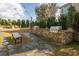 Outdoor kitchen area featuring built-in grill, stone counter, and slate paver path with a charming bench nearby at 1225 Blakeway St # 403, Charleston, SC 29492