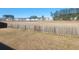 View of open community space from behind a rustic wooden fence and backyard at 126 Shadybrook Dr, Summerville, SC 29486
