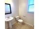 Powder room showcasing a pedestal sink, toilet, and a large mirror at 126 Shadybrook Dr, Summerville, SC 29486