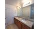 Bathroom boasts double sinks with granite countertops, cabinet storage, and large mirror at 126 Shadybrook Dr, Summerville, SC 29486