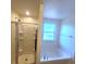 Bright bathroom featuring a shower and a soaking tub, illuminated by a window at 126 Shadybrook Dr, Summerville, SC 29486