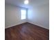 Bedroom features neutral paint, window, and wood flooring at 126 Shadybrook Dr, Summerville, SC 29486