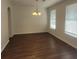 Bright dining room featuring hardwood floors, elegant chandelier, and ample natural light at 126 Shadybrook Dr, Summerville, SC 29486