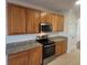 Stylish kitchen featuring stainless steel oven, granite countertops, and wood cabinetry at 126 Shadybrook Dr, Summerville, SC 29486