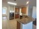 Well-lit kitchen with stainless steel fridge, granite countertops and breakfast bar at 126 Shadybrook Dr, Summerville, SC 29486