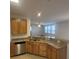 Modern kitchen with stainless steel dishwasher, granite countertops, and wooden cabinets at 126 Shadybrook Dr, Summerville, SC 29486