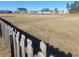 View of open community space from behind a rustic wooden fence in a residential neighborhood at 126 Shadybrook Dr, Summerville, SC 29486