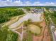 Community aerial view featuring a large pond, walking paths, and lush landscaping, offering a serene environment at 127 Country Gate Ln, Summerville, SC 29485