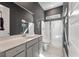 Bathroom features gray vanity, framed mirror, shower with glass door, and white marble tile floor at 127 Country Gate Ln, Summerville, SC 29485