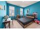 Blue bedroom featuring natural light, a study desk, and bed with black bedding at 127 Country Gate Ln, Summerville, SC 29485