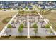 Aerial view of community space with seating and firepits surrounded by new homes at 127 Country Gate Ln, Summerville, SC 29485