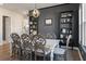 Formal dining room with black accent wall, built-in shelving, and stylish light fixture at 127 Country Gate Ln, Summerville, SC 29485