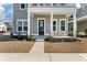 Inviting front porch featuring elegant columns, fresh landscaping, and a welcoming bench at 127 Country Gate Ln, Summerville, SC 29485