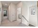 Hallway with neutral carpet and white walls leads to laundry and other rooms at 127 Country Gate Ln, Summerville, SC 29485