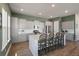 Bright kitchen features white cabinets, stainless appliances, and island with bar stool seating at 127 Country Gate Ln, Summerville, SC 29485