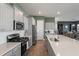 Open kitchen design boasts gray cabinets, stainless appliances, and a long quartz countertop at 127 Country Gate Ln, Summerville, SC 29485
