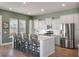 Modern kitchen with stainless steel appliances, white cabinets, quartz countertops, and kitchen island seating at 127 Country Gate Ln, Summerville, SC 29485