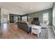 Bright living room with a cozy sofa, accent chairs, and hardwood floors, perfect for relaxation and entertaining at 127 Country Gate Ln, Summerville, SC 29485